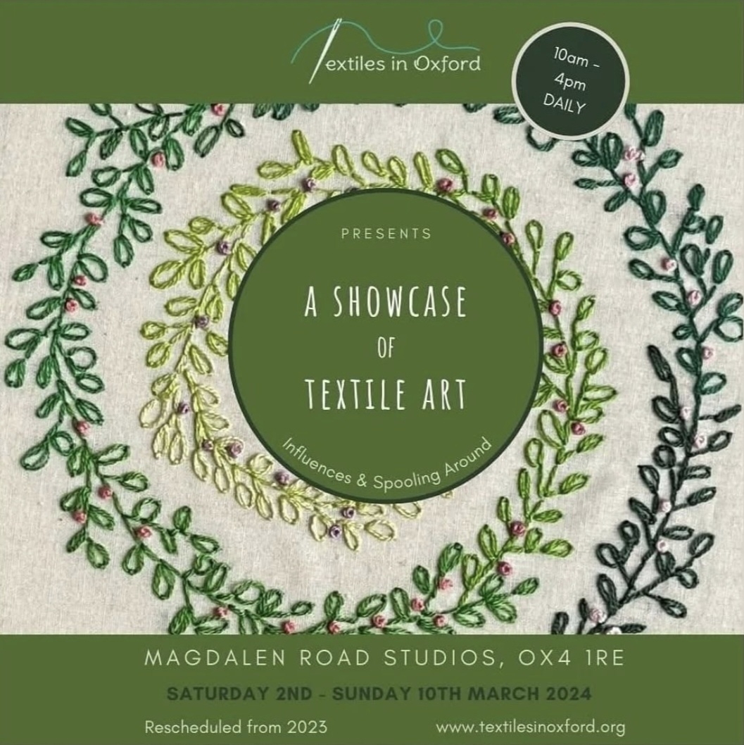 Dark and light green poster with 'Textile Art Showcase' text in a dark green circle in the centre surrounded by embroidered leaved